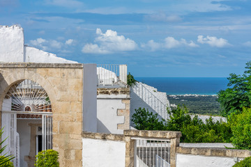 A view of the Adriatic sea and traditional white houses in Ostuni in the Puglia region of Italy