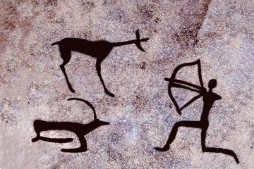image of an ancient hunter with a bow and animals on the cave wall. ancient history, archaeology.