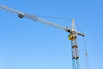 tower crane boom is rotated to the left, blue sky