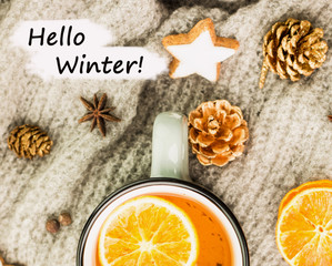 Fototapeta na wymiar Winter theme. Hot tea with spices,orange,cinnamon,anise,cookies