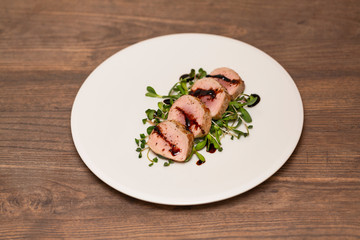 Hot Pork Tenderloin with Herbs and Spices on white plate with sauce. Selective focus. Food background