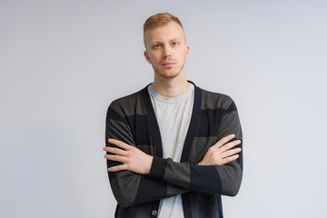 Studio portrait concept of a smiling young man talking on a white background.