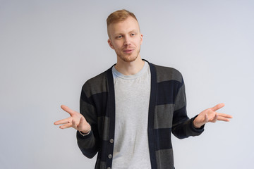 Studio portrait concept of a smiling young man talking on a white background.
