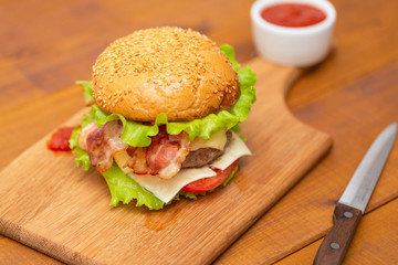 Fresh tasty burger on wood table