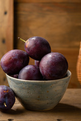 Fresh plums in small bowl
