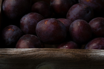 Fototapeta na wymiar Ripe plums in wooden crate