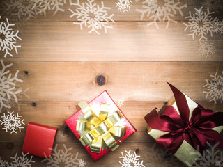 christmas decoration with wood  background.gift box top view on wood table.snow graphic pattern.