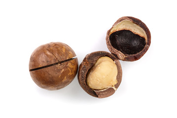 Shelled and unshelled macadamia nuts isolated on white background. Top view. Flat lay pattern