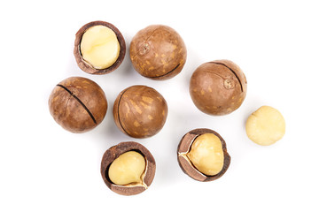 Shelled and unshelled macadamia nuts isolated on white background. Top view. Flat lay pattern