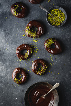 Doughnuts with chocolate ganache and pistachios