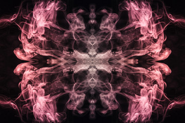 Abstract thick colored smoke on a black background with a monster face. The concept of light laser show at a musical concert and a print on a T-shirt