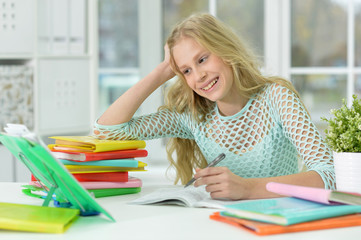 Portrait of a cute schoolgirl studying at home