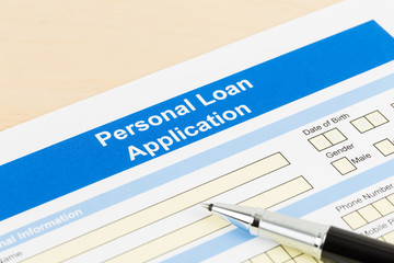 Personal loan application form with pen