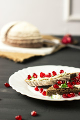 sandwich with cheese, greens and pomegranate berries