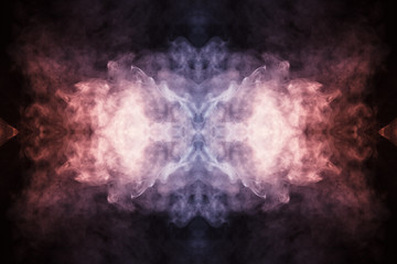 Abstract thick colored smoke on a black background with a monster face. The concept of light laser...