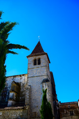 Fototapeta na wymiar The spire of Eglise Saint-Dominique in the medieval bastide village of Monpazier in the Dordogne region of France