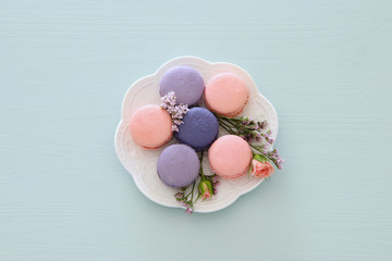 Top view of colorful macaron or macaroon over pastel blue background. Flat lay.
