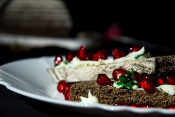 sandwich with cheese, greens and pomegranate berries