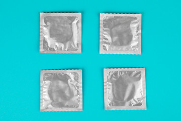 Condom on a blue background. The concept of safe sex.