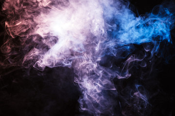 Colored smoke on a black background. The concept of light show at a music concert
