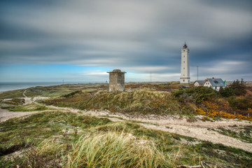Fototapeta na wymiar Long exposure of a lighthouse at a beach in Denmark