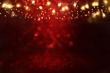 Fototapeta na wymiar Red, black and gold glitter lights background. defocused.
