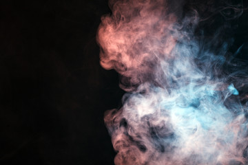 Colored smoke on a black background. The concept of light show at a music concert