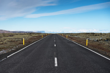 Empty road leading to snow covered mountains, Beautiful landscape in early winter of south Iceland