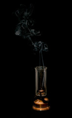 Old oil lamp with smoke on dark background