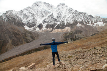 Happy boy enjoying a magnificent mountain view