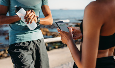 Couple relaxing after workout outdoors