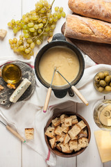 Dipping into a delicious cheese fondue made with a blend of assorted melted cheeses and wine