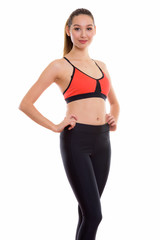 Naklejka premium Studio shot of young beautiful Asian woman posing with both hand