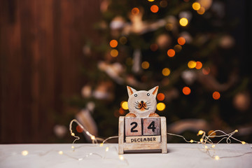 December 24th on the perpetual calendar. Perpetual calendar on a background of bokeh garlands....