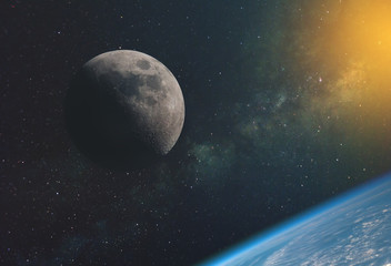 the moon against the milky way and the rays of the sun in the infinite space of the universe in orbit of the earth. Elements of this image furnished by NASA