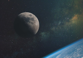 the moon against the milky way and the rays of the sun in the infinite space of the universe in...