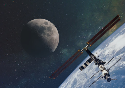 the moon against the milky way and the international space station in the infinite space of the universe in orbit of the earth. Elements of this image furnished by NASA