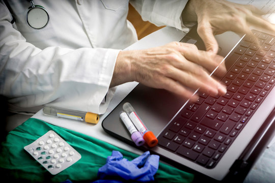 hands of doctor writing fast on laptop, conceptual image