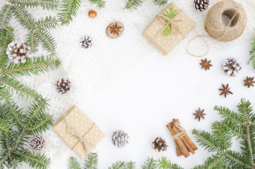 Christmas composition. Christmas gift, coil of rope, pine cones, fir branches on white background. Flat lay, top view, copy space hero header