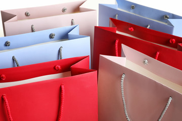 Colorful paper shopping bags as background, closeup