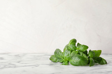 Fresh green basil leaves on table. Space for text