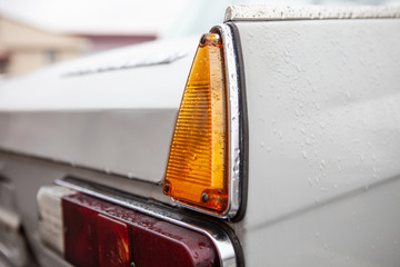 Right taillights of a retro car, after the rain