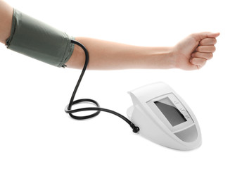 Woman using modern digital sphygmomanometer for checking blood pressure and pulse on white...