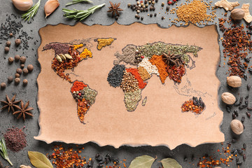 Paper with world map made of different aromatic spices on gray background, flat lay