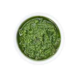 Fototapeta premium Homemade basil pesto sauce in bowl on white background