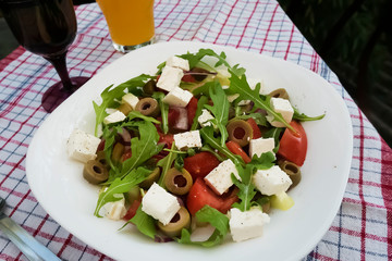 Greek salad on white plate.