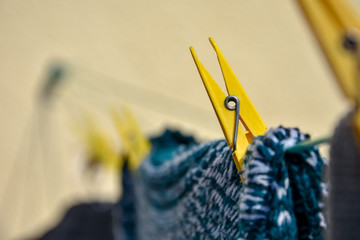 yellow clothespins with clothes