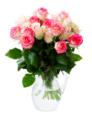 Rose fresh flowers bouquet in two shades of pink in glass vase isolated on white background