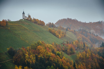 Beautiful autumn at Church of St. Primus and Felician, Jamnik, Slovenia .