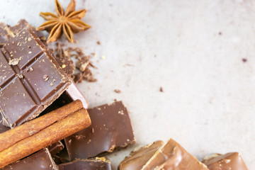 Dark chocolate pieces crushed and cocoa beans, culinary background, top view